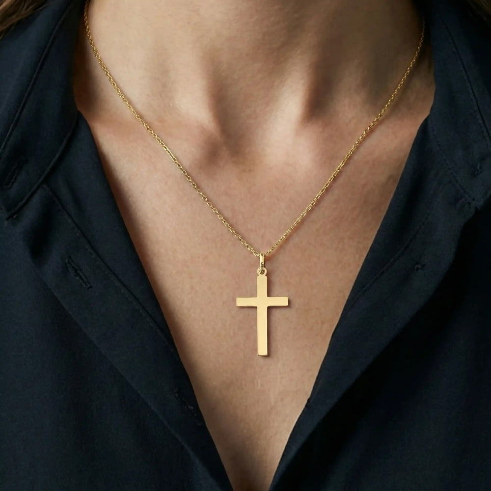 Minimal Latin Yellow Gold Cross Pendant worn on womens chest