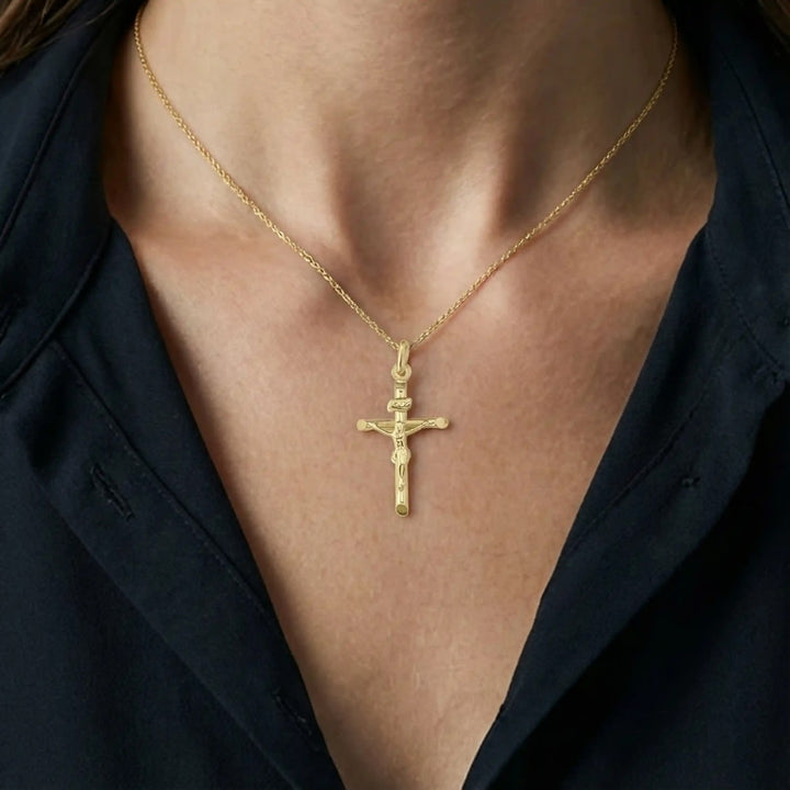 Tubular Crucifix Yellow Gold Cross Pendant worn on womens chest