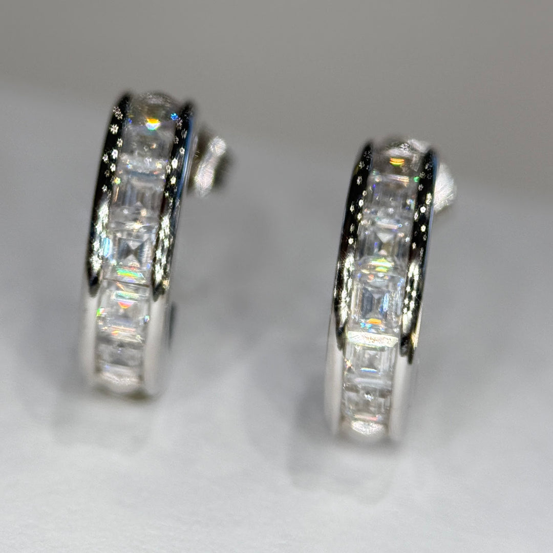 14k white gold moissanite three-quarter hoops standing, channels toward camera
