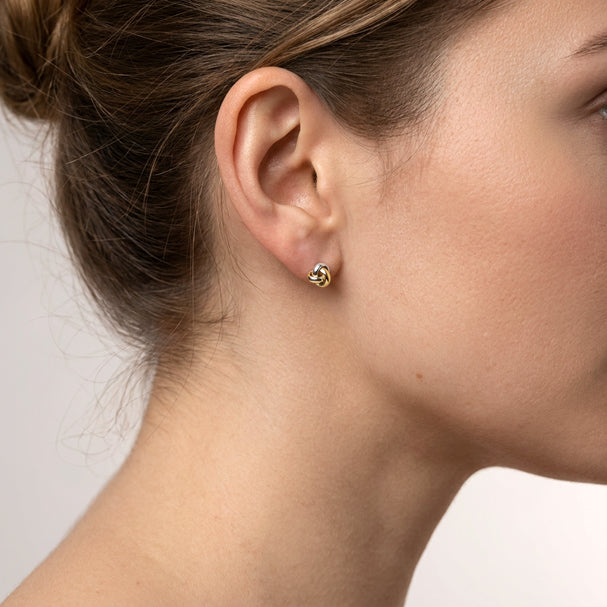 Two Tone Love Knot Stud Earrings - worn on ear