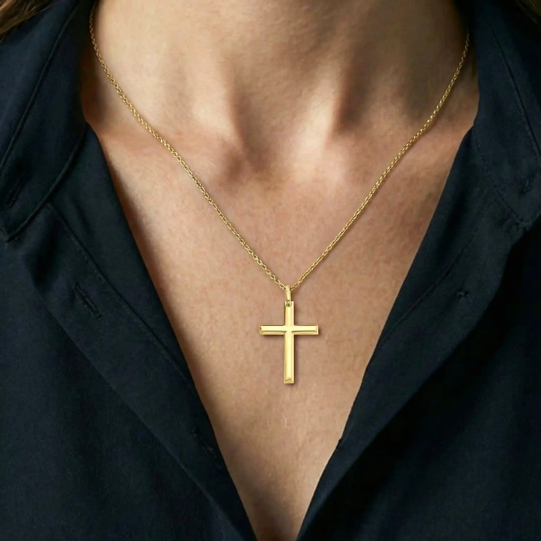 Minimal Latin Yellow Gold Cross Pendant worn on womens chest