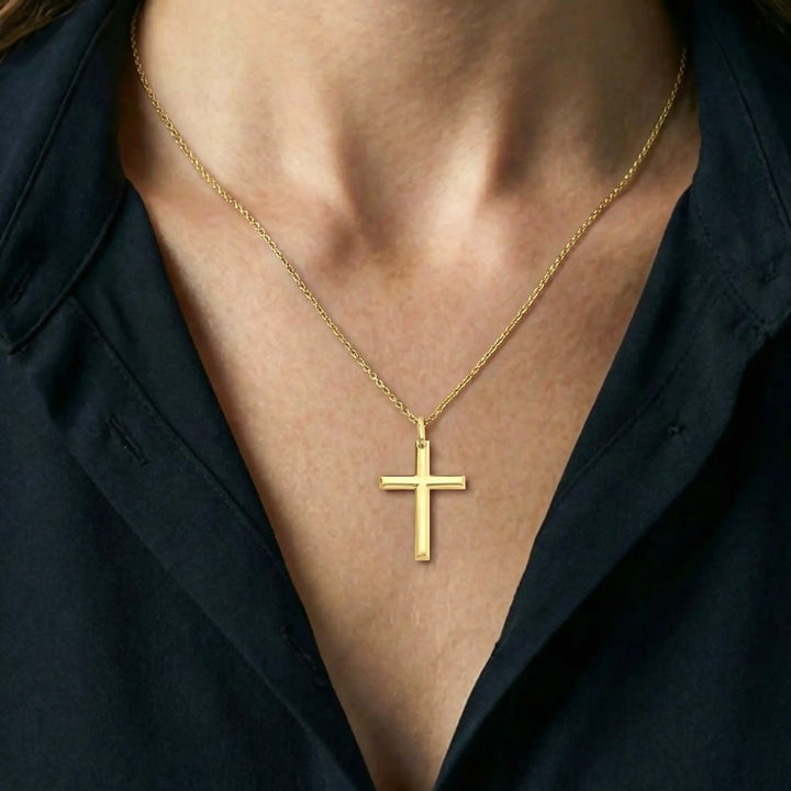 Minimal Latin Yellow Gold Cross Pendant worn on womens chest