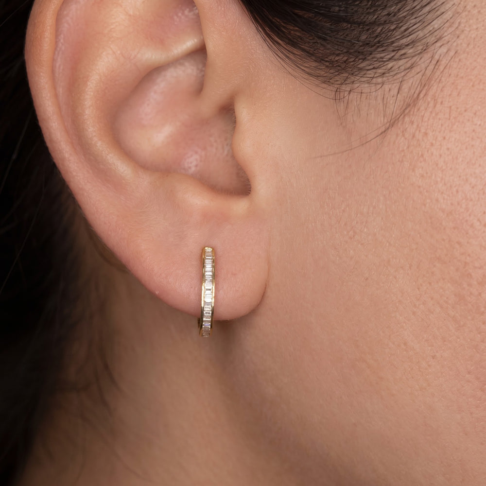 14k yellow gold natural diamond baguette huggie worn on the ear