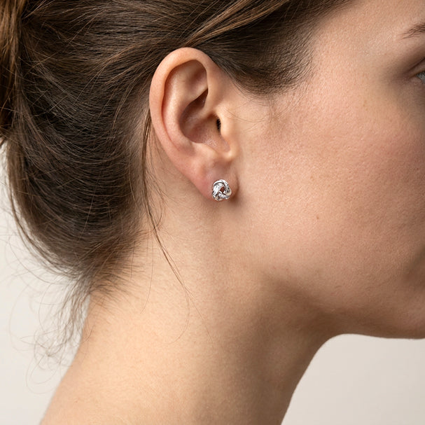 White Gold Love Knot Earrings - worn on ear