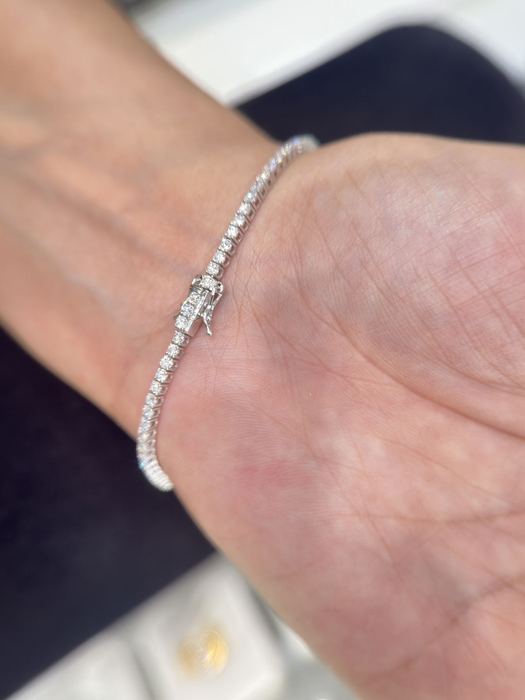Tennis bracelet clasp shown on the wrist