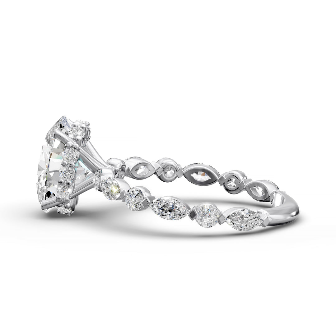Oval hidden halo engagement ring with alternating marquise and round diamond band shown in studio lighting
