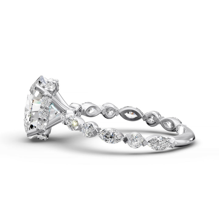 Oval hidden halo engagement ring with alternating marquise and round diamond band shown in studio lighting
