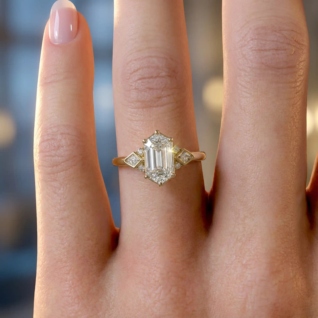 Elongated hexagonal lab-grown diamond engagement ring with side stones on a polished surface.
