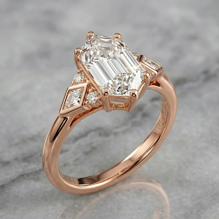 Elongated hexagonal lab-grown diamond engagement ring with side stones on a polished surface.

