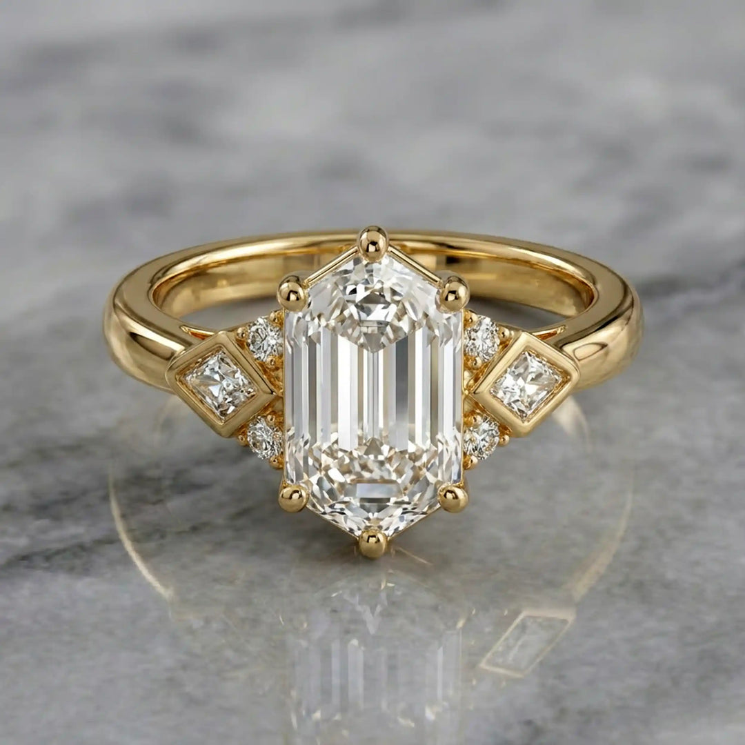 Elongated hexagonal lab-grown diamond engagement ring with side stones on a polished surface.

