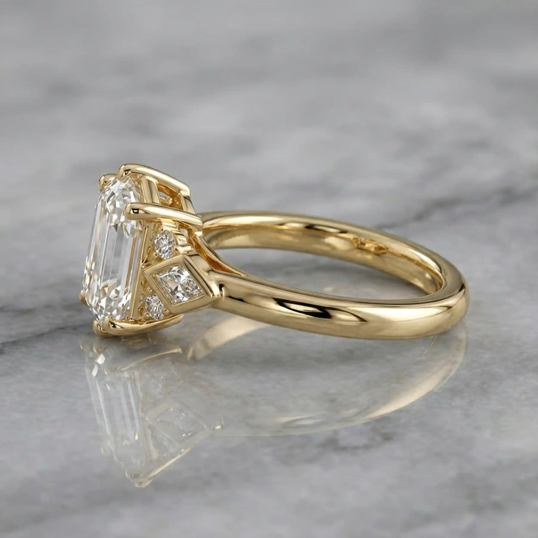 Elongated hexagonal lab-grown diamond engagement ring with side stones on a polished surface.

