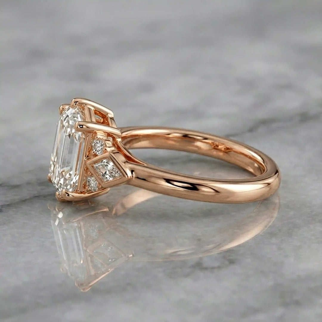 Elongated hexagonal lab-grown diamond engagement ring with side stones on a polished surface.
