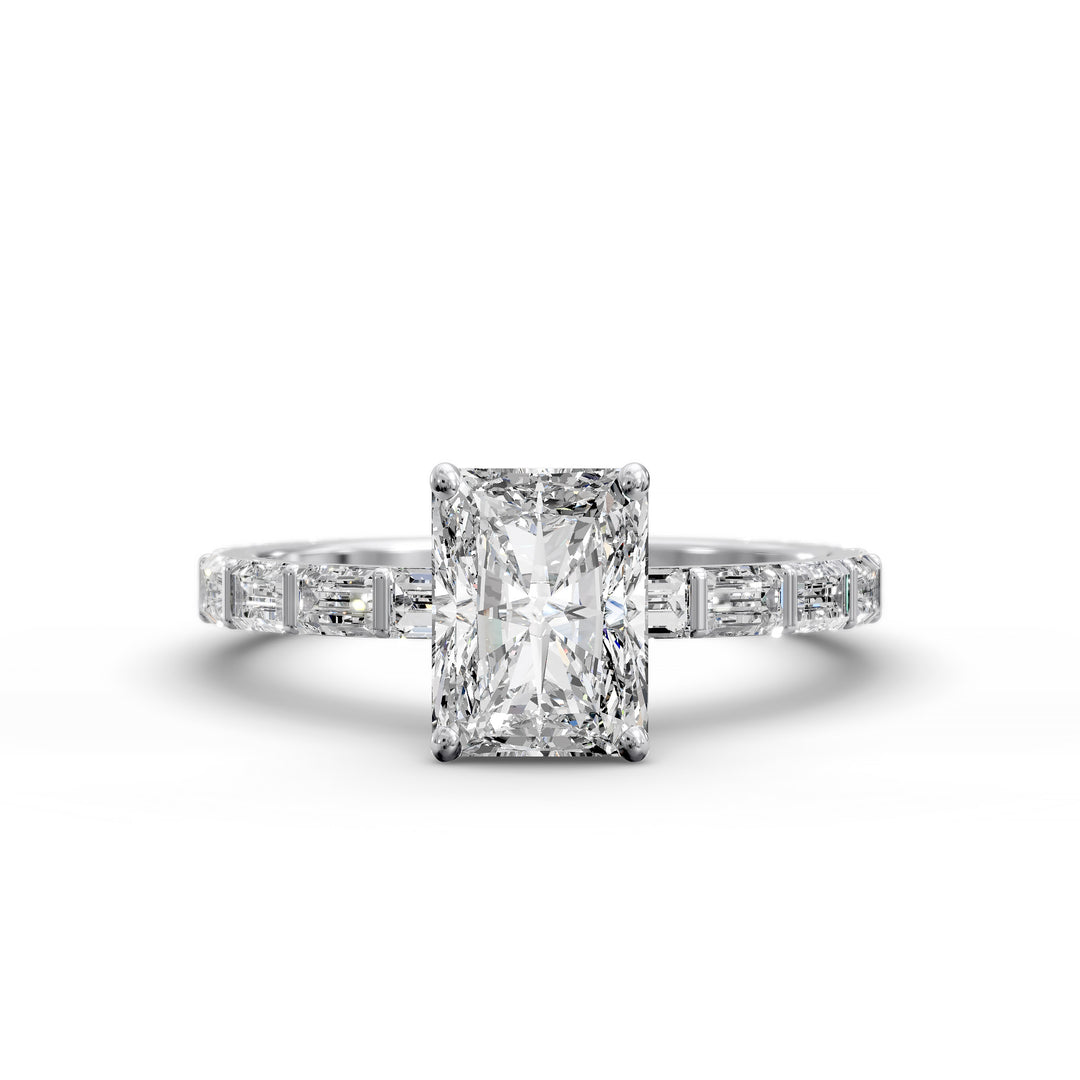 Radiant-cut diamond engagement ring with baguette diamond band shown in studio lighting.