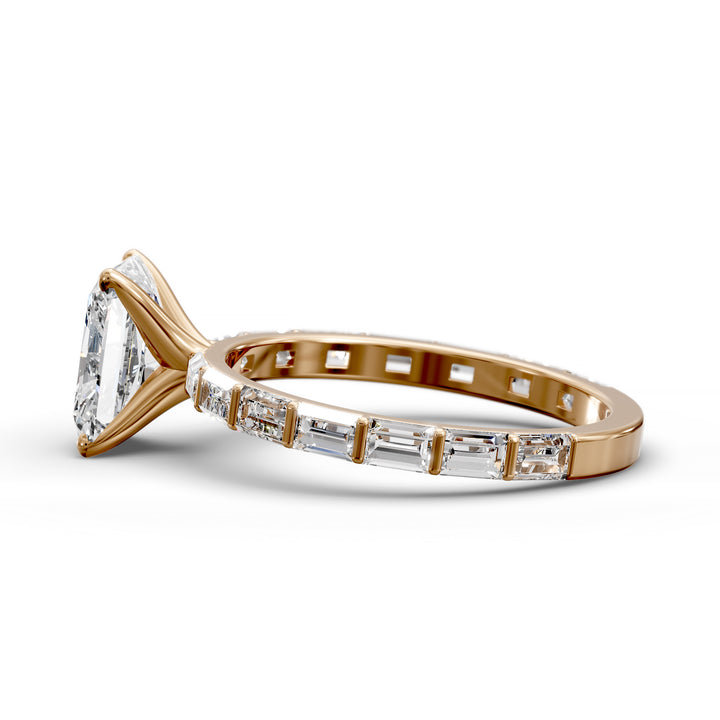 Radiant-cut diamond engagement ring with baguette diamond band shown in studio lighting.