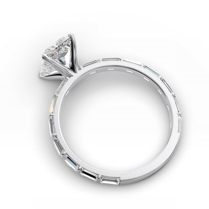 Radiant-cut diamond engagement ring with baguette diamond band shown in studio lighting.