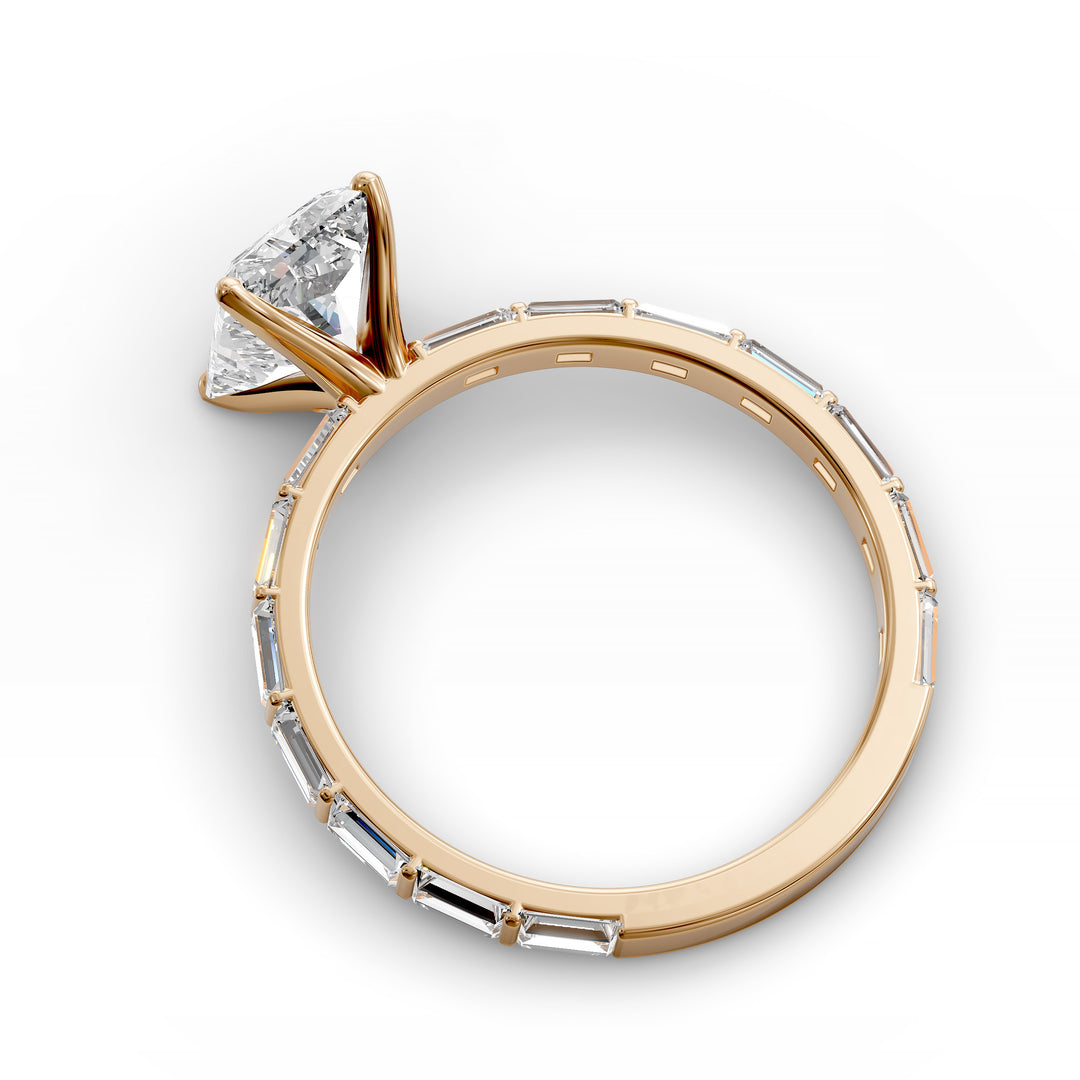 Radiant-cut diamond engagement ring with baguette diamond band shown in studio lighting.