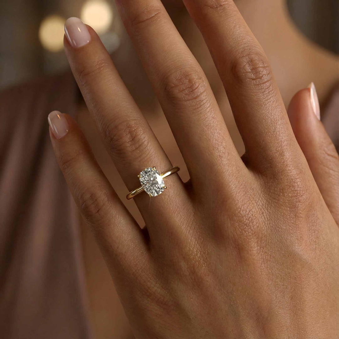 Elongated cushion diamond hidden halo cathedral engagement ring shown on display.
