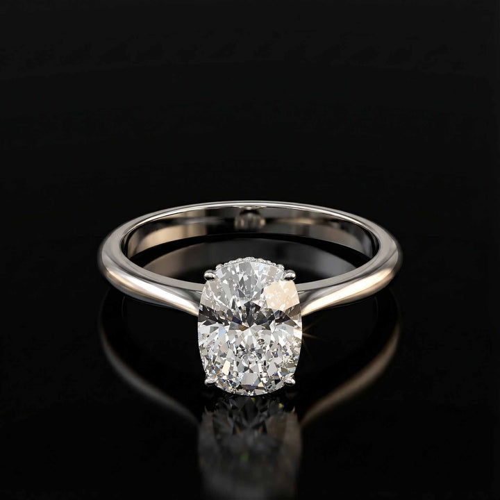 Elongated cushion diamond hidden halo cathedral engagement ring shown on display.
