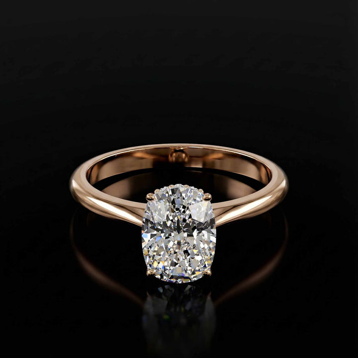 Elongated cushion diamond hidden halo cathedral engagement ring shown on display.

