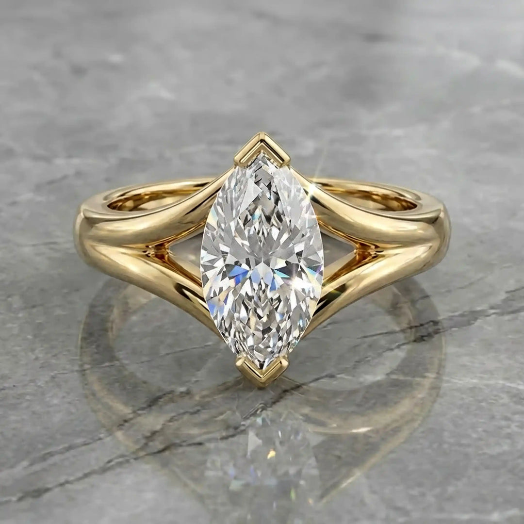 2 carat lab-grown marquise diamond split shank solitaire engagement ring displayed on stone surface.