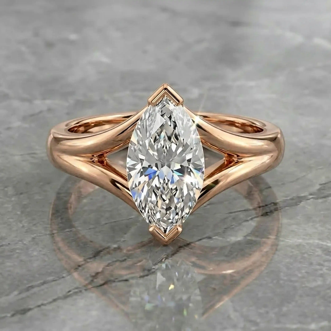 2 carat lab-grown marquise diamond split shank solitaire engagement ring displayed on stone surface.