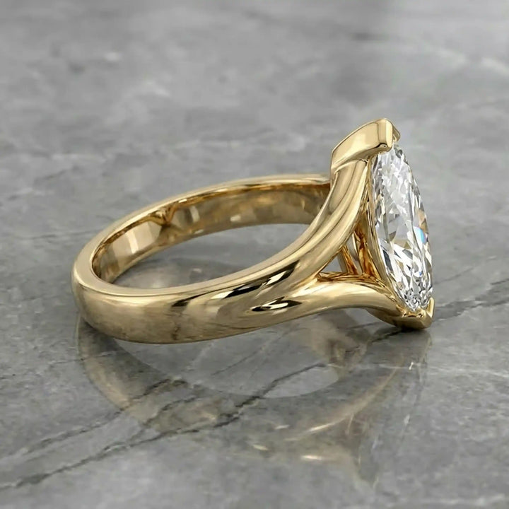 2 carat lab-grown marquise diamond split shank solitaire engagement ring displayed on stone surface.