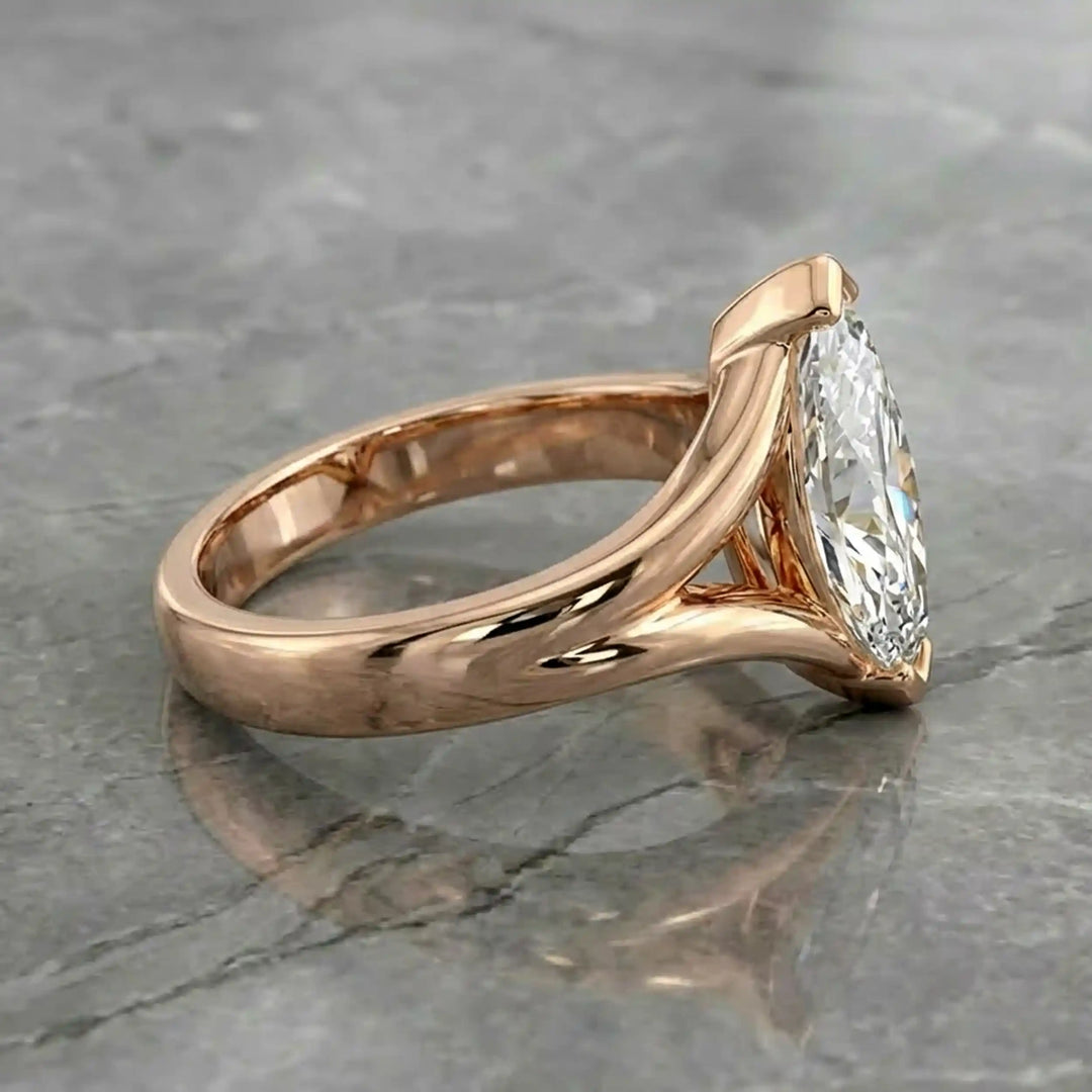 2 carat lab-grown marquise diamond split shank solitaire engagement ring displayed on stone surface.