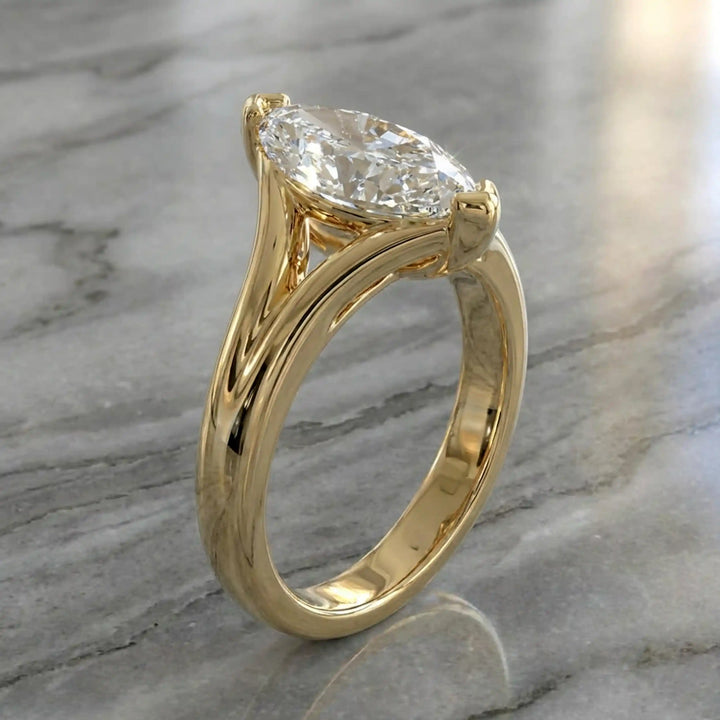 2 carat lab-grown marquise diamond split shank solitaire engagement ring displayed on stone surface.