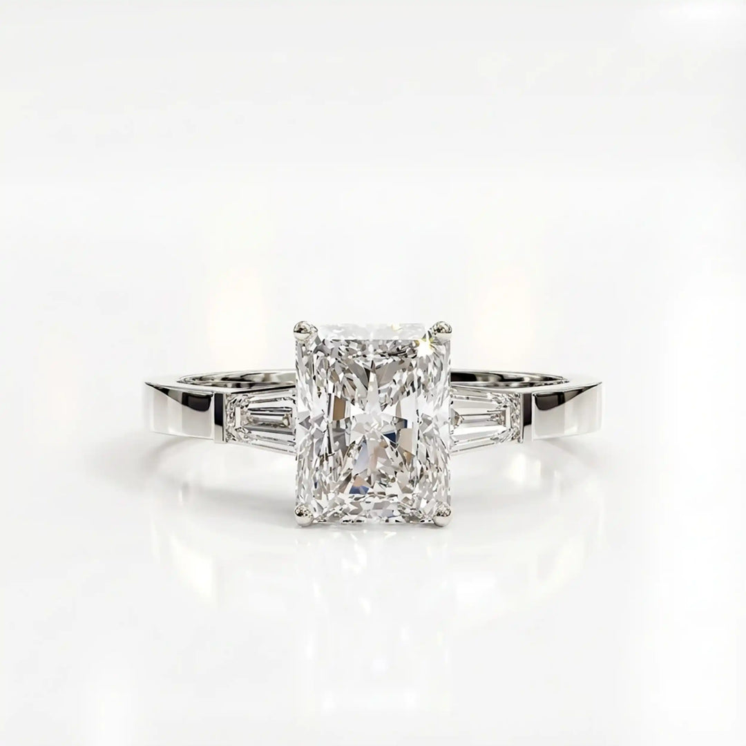 Radiant cut lab diamond three-stone engagement ring shown white surface.