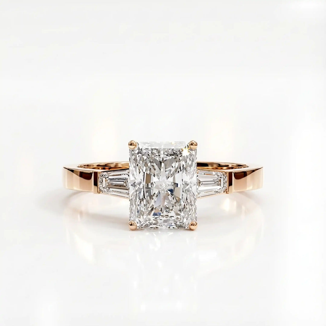 Radiant cut lab diamond three-stone engagement ring shown white surface.