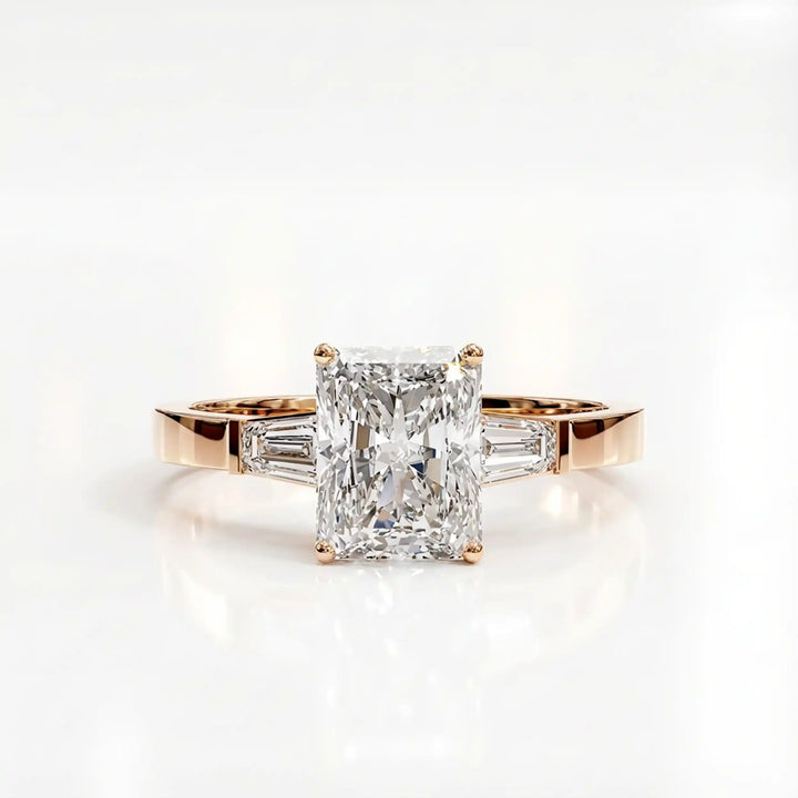 Radiant cut lab diamond three-stone engagement ring shown white surface.