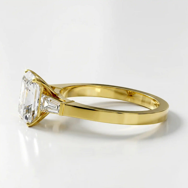 Radiant cut lab diamond three-stone engagement ring shown white surface.