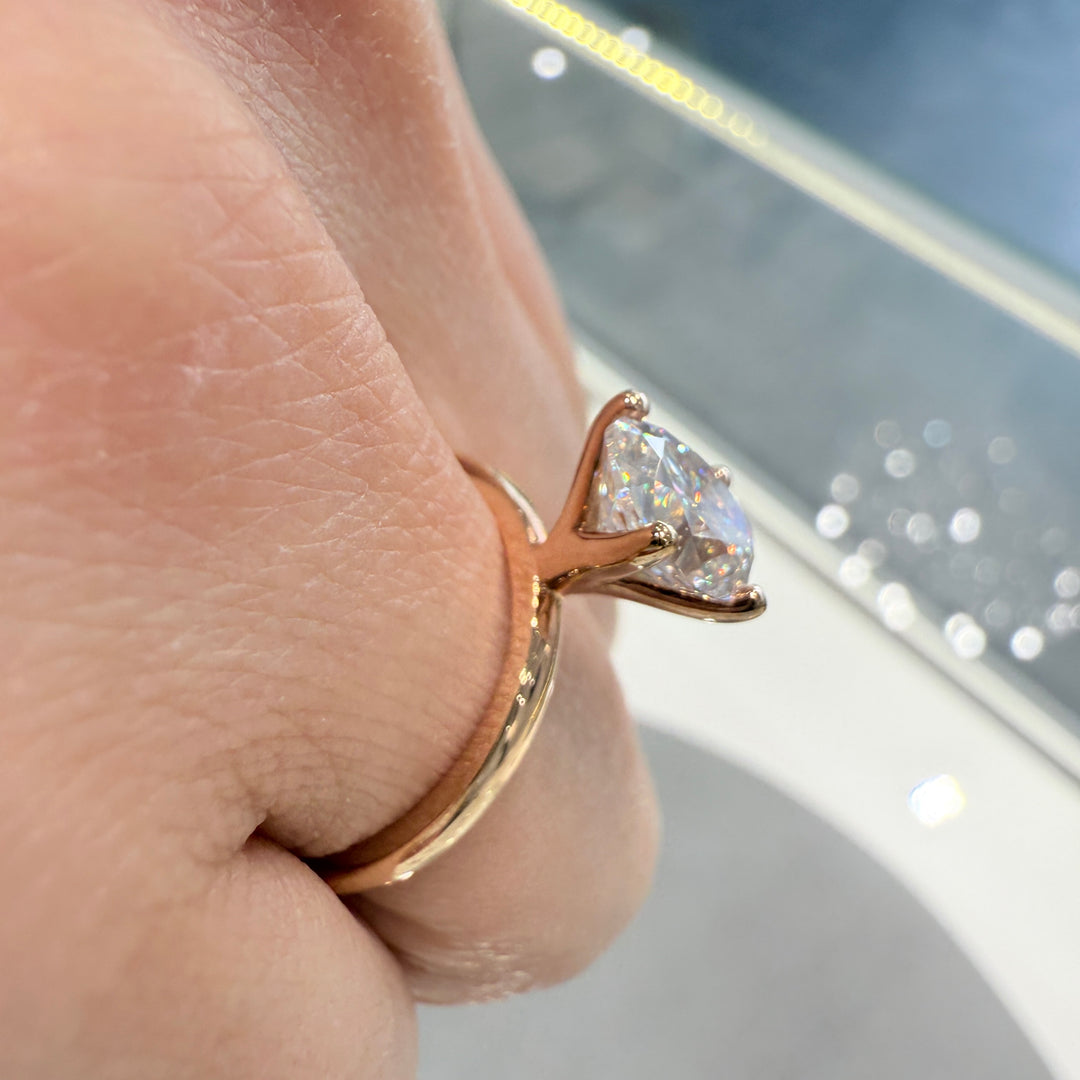 2.2 Ct oval solitaire moissanite engagement ring in 18K gold.