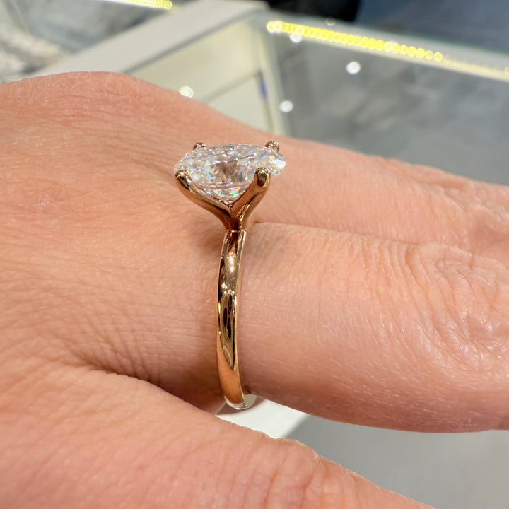 2.2 Ct oval solitaire moissanite engagement ring in 18K gold.