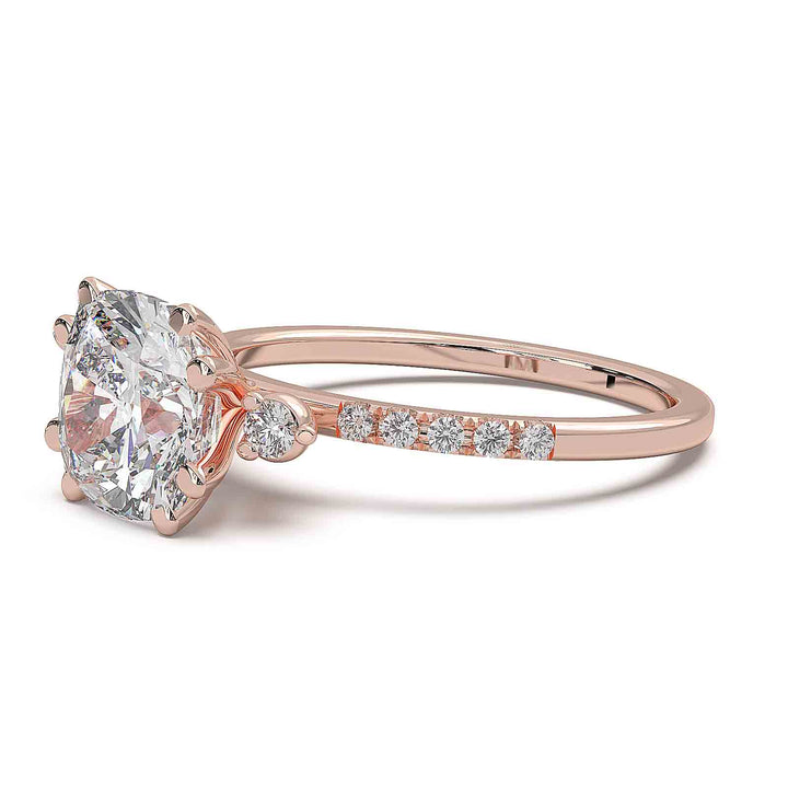 cushion-cut diamond engagement ring with pave-set diamond band and side stones