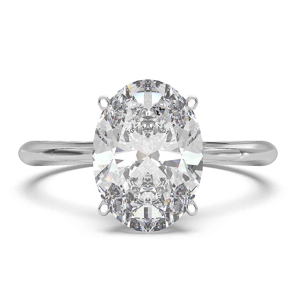 Oval diamond hidden halo engagement ring with cathedral setting and elegant prongs.