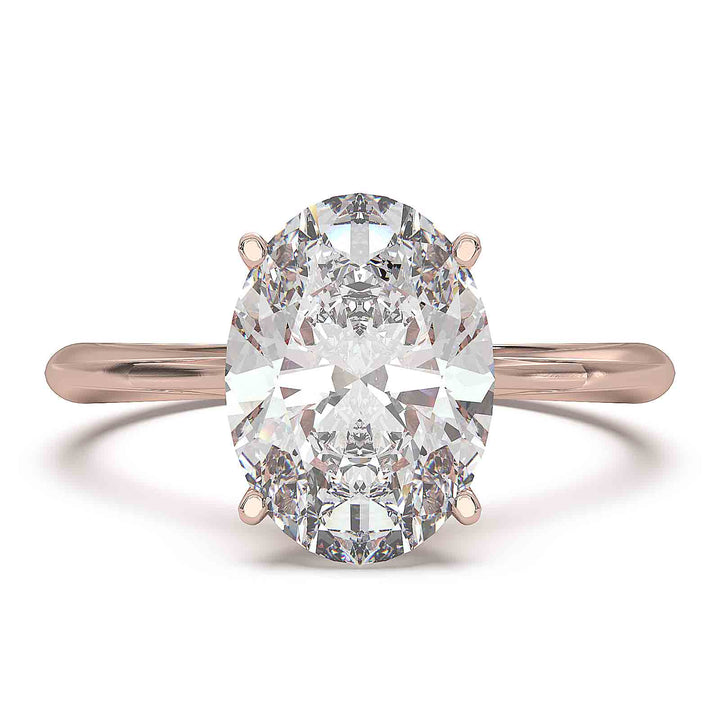 Oval diamond hidden halo engagement ring with cathedral setting and elegant prongs.