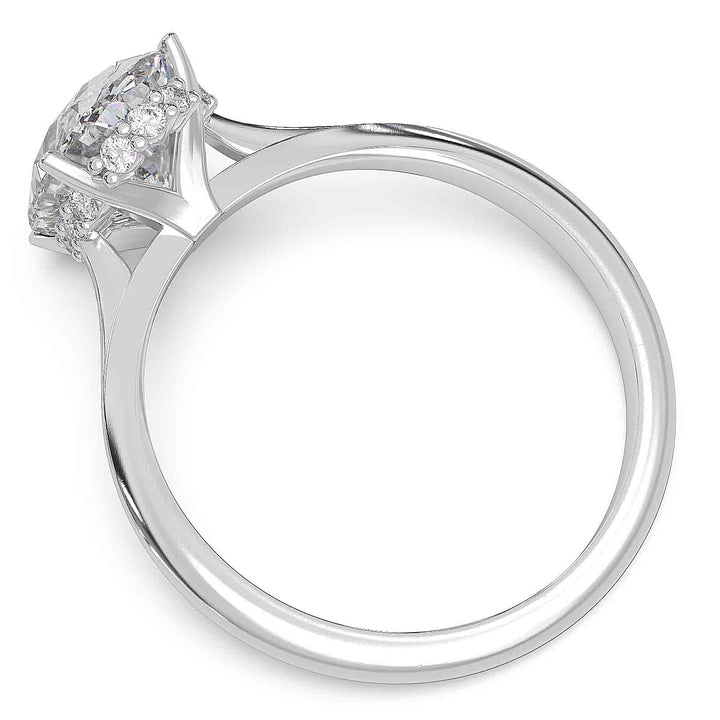 Oval diamond hidden halo engagement ring with cathedral setting and elegant prongs.