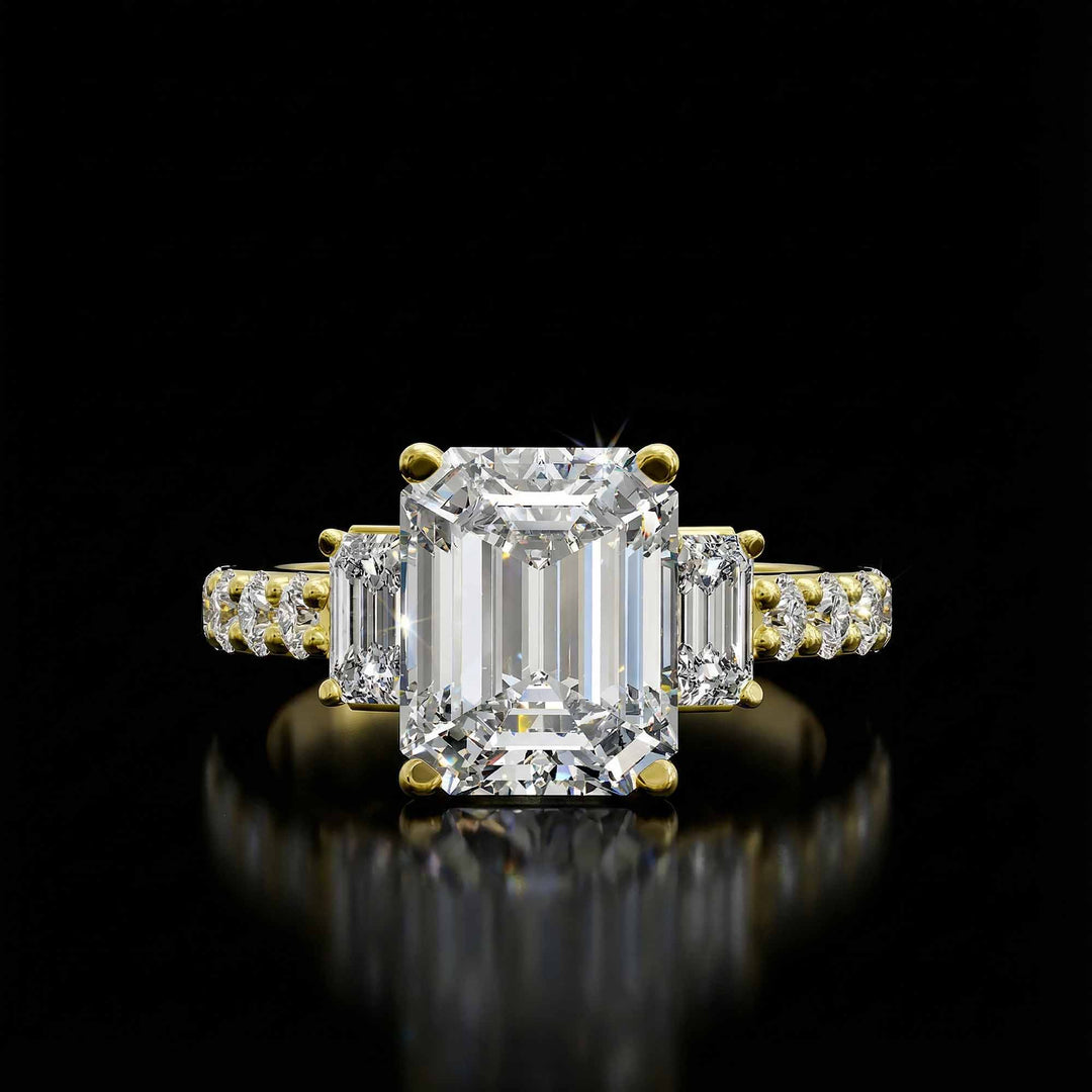 Emerald cut three stone diamond engagement ring with pavé band on display.

