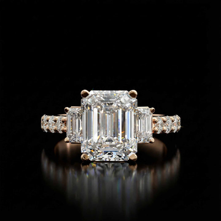 Emerald cut three stone diamond engagement ring with pavé band on display.
