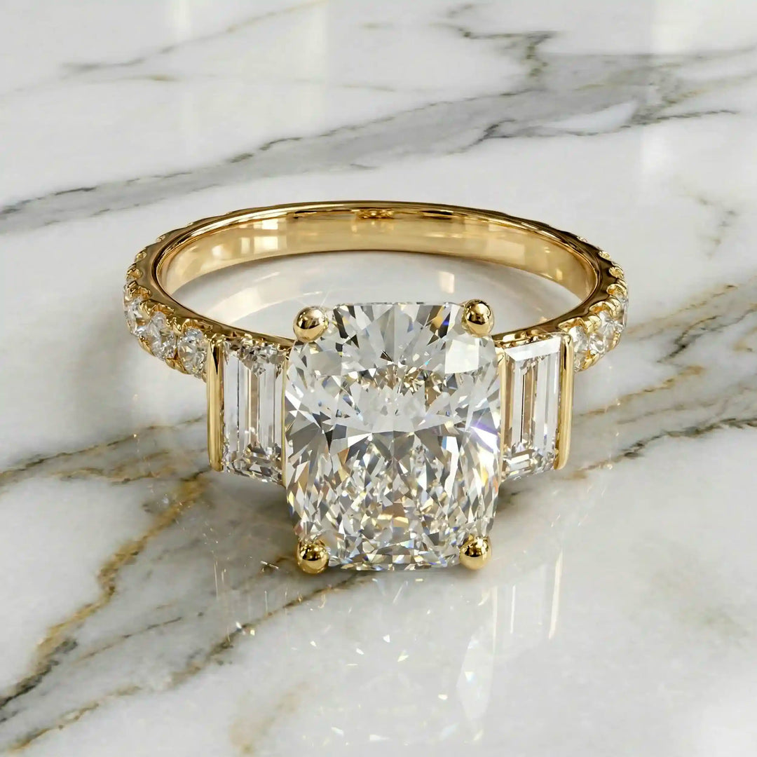 Elongated cushion three stone lab-grown diamond engagement ring displayed on marble surface.