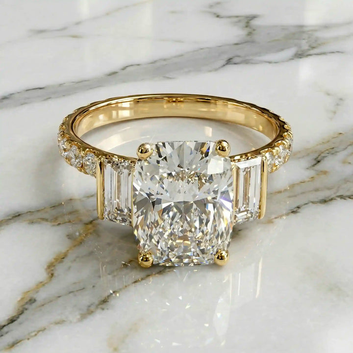 Elongated cushion three stone lab-grown diamond engagement ring displayed on marble surface.