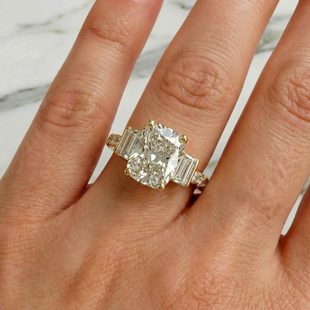 Elongated cushion three stone lab-grown diamond engagement ring displayed on hand.