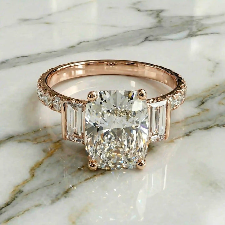 Elongated cushion three stone lab-grown diamond engagement ring displayed on marble surface.