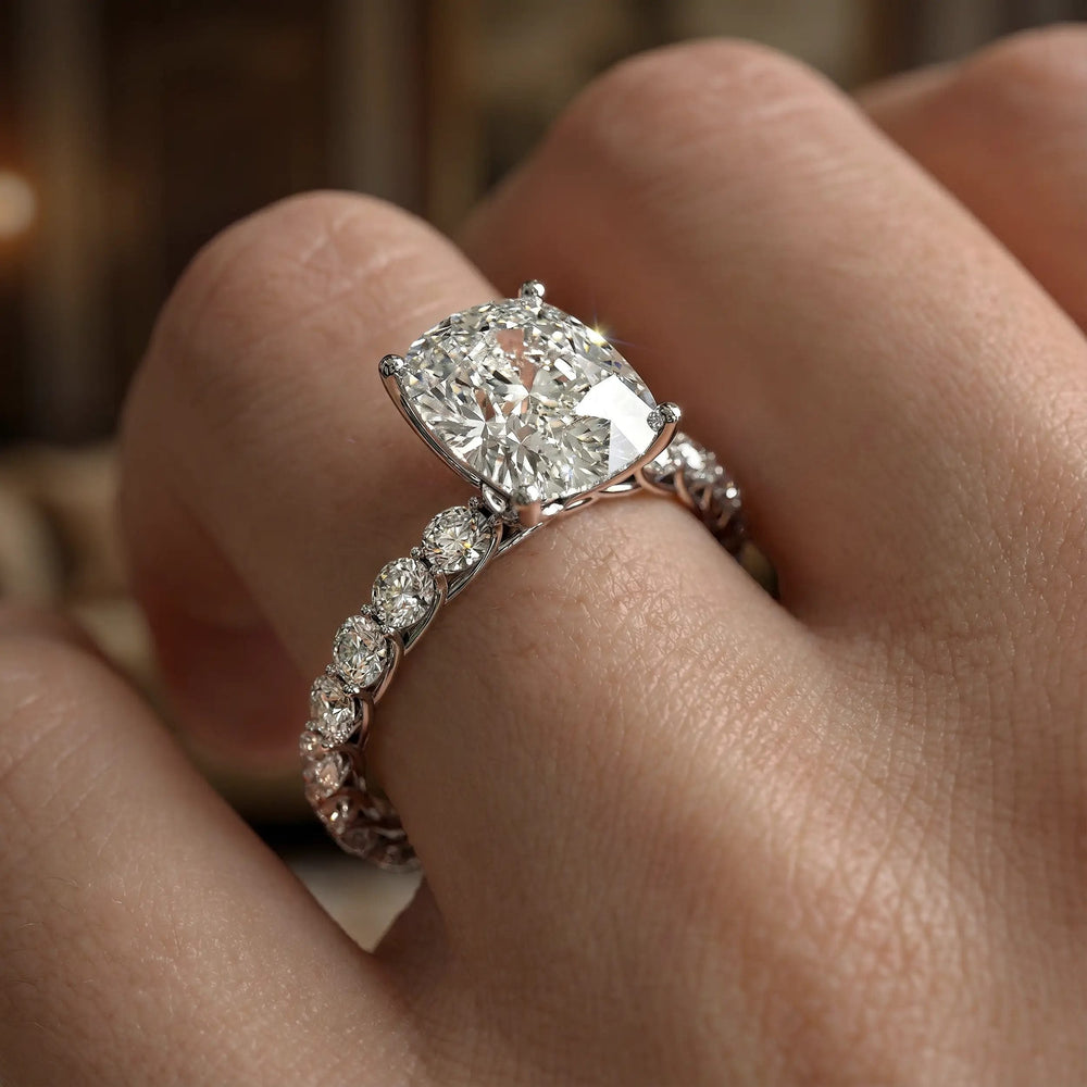 Elongated cushion diamond engagement ring with shared prong band shown in a studio display.