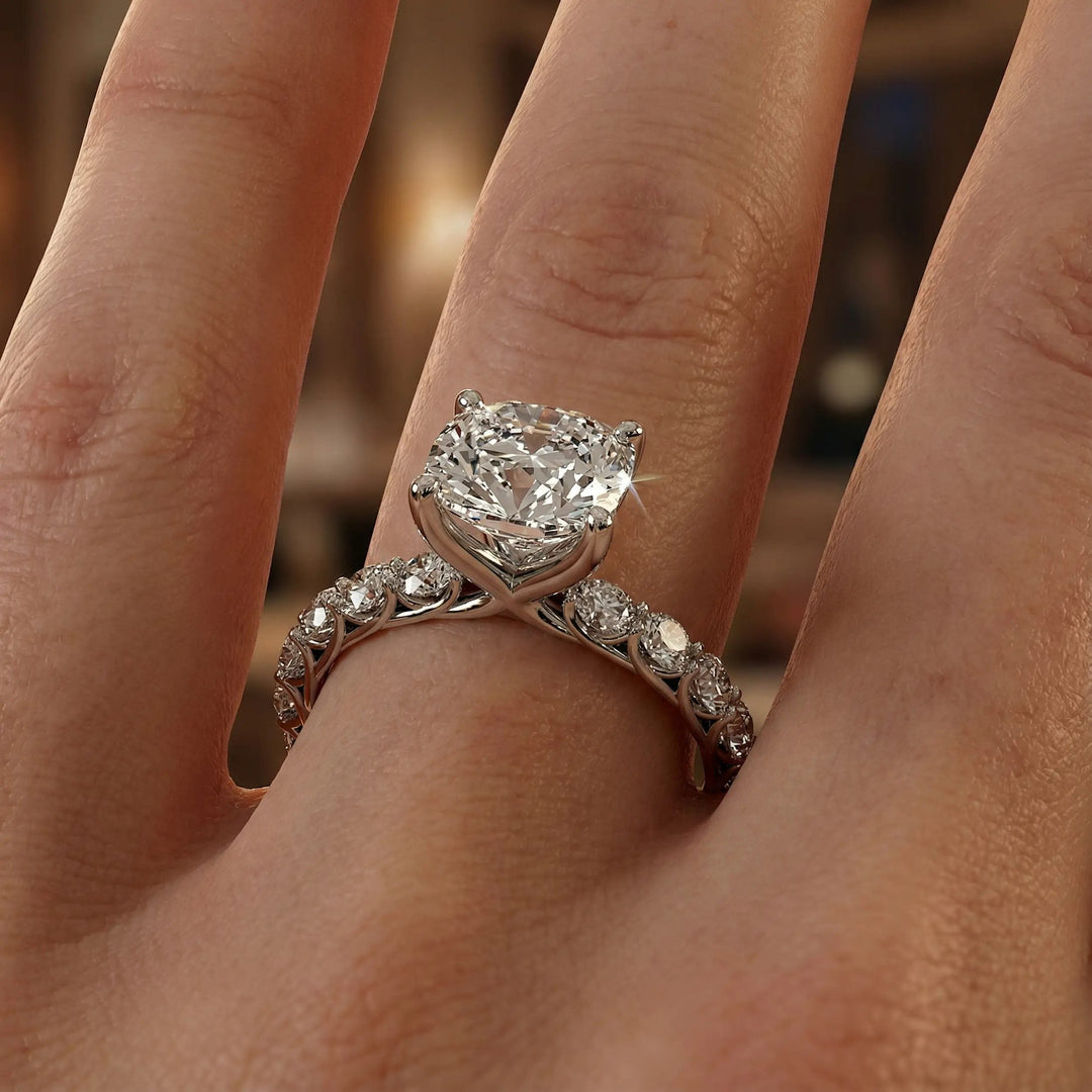 Elongated cushion diamond engagement ring with shared prong band shown in a studio display.