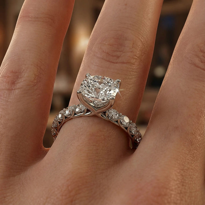 Elongated cushion diamond engagement ring with shared prong band shown in a studio display.