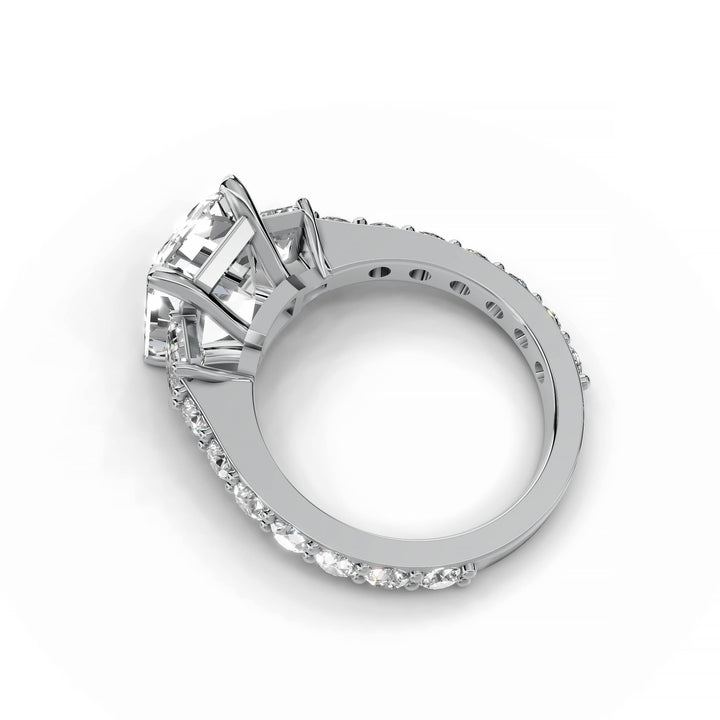 Emerald cut diamond three-stone engagement ring in white gold.