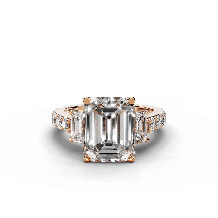 Emerald cut diamond engagement ring with three stones in rose gold.