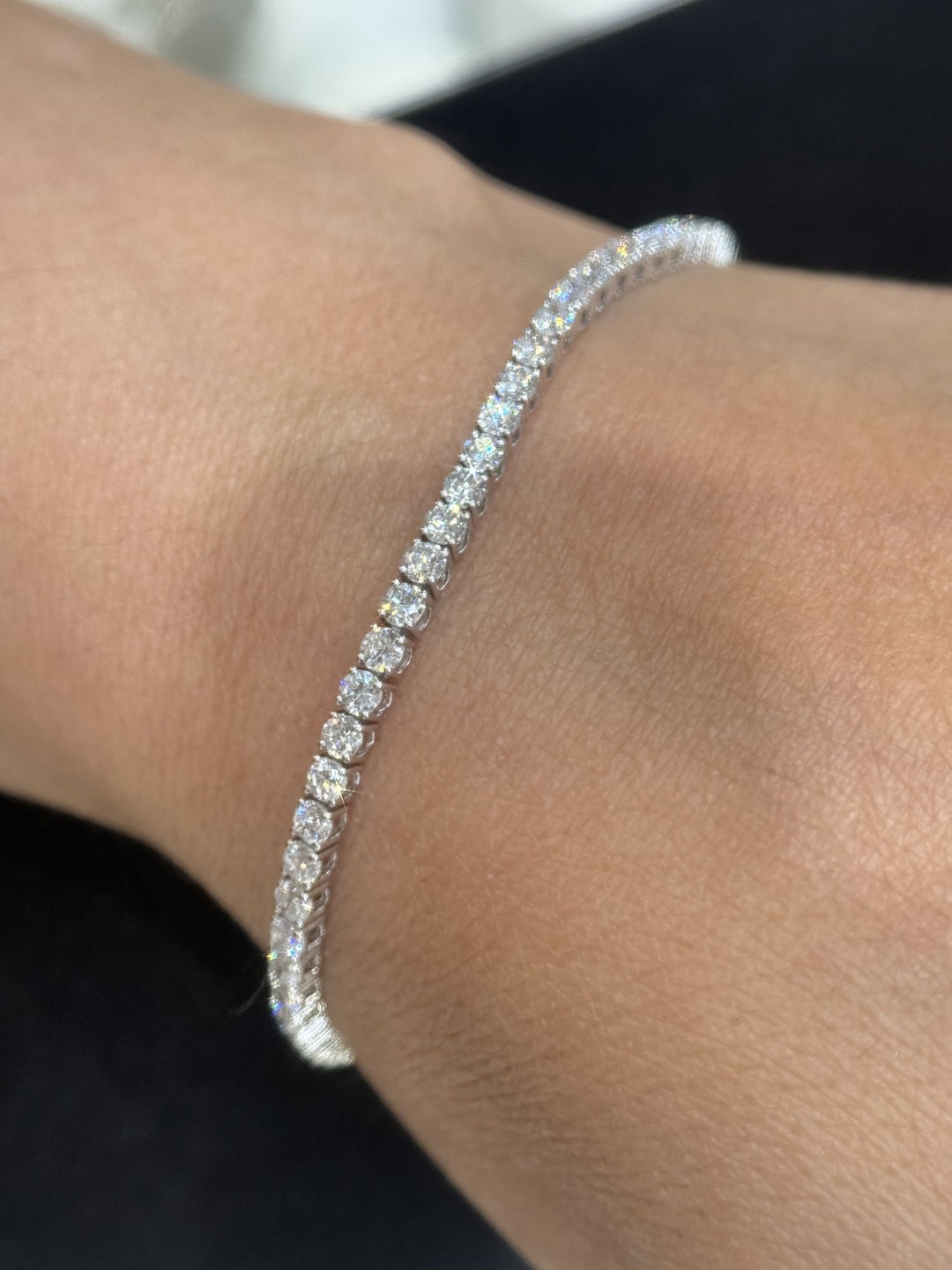Round lab-grown diamond tennis bracelet shown on the wrist